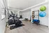 Modern home gym with sleek exercise equipment, vibrant fitness balls, and ample space for workouts.