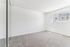 Bright, spacious bedroom with soft carpet, large window, and mirrored closet doors, ready for personalized styling.