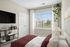 Elegant bedroom with stylish decor, showcasing large window with scenic view, cozy bed, and modern shelving unit.
