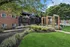 Inviting leasing office entrance at a modern apartment complex, surrounded by lush greenery and contemporary architecture.