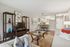 Inviting open-concept apartment living room with modern decor, cozy seating, and adjacent dining area leading to a bright kitchen.
