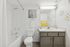 Bright, modern bathroom with elegant white fixtures, sleek vanity, and charming daisy wall decor, creating a fresh and inviting atmosphere.