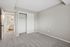 Inviting bedroom with plush carpeting, built-in closet, and ensuite bathroom offering modern elegance and comfort.