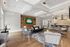 Luxurious and inviting living space featuring modern decor, cozy seating, stylish bar area, and a touch of greenery for an elegant atmosphere.