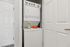 Compact apartment laundry area with modern stacked washer and dryer, neatly integrated for functional living.