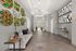 Elegant apartment lobby with stylish geometric wall art, cozy seating area, chic lighting, and modern tile flooring.