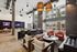 Modern communal lounge with sleek seating, large windows, and contemporary lighting, perfect for relaxation and social gatherings.