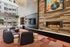 Sophisticated lounge with modern fireplace, plush seating, and stylish decor overlooking a serene pool area.
