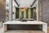 Modern kitchen with elegant white countertops, industrial lighting, and a lush green wall for a stylish urban vibe.