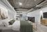 Chic industrial-style bedroom loft featuring exposed ductwork, sleek furnishings, and abundant natural light.