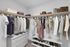 Spacious walk-in closet showcasing an organized array of stylish clothing, shoes, and storage boxes, highlighting modern living luxury.