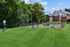 Inviting dog park with agility equipment set amidst lush greenery, perfect for pet-friendly apartments.