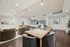 Elegant open-concept living space featuring cozy seating, modern art, and a stylish dining area, perfect for entertaining.