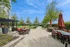 Luxurious outdoor terrace featuring elegant seating, lush greenery, and shaded areas perfect for relaxation and social gatherings.