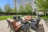 Luxurious outdoor patio with cozy fire pit, surrounded by elegant seating and lush greenery, perfect for relaxing or entertaining.
