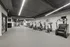 Modern fitness center with state-of-the-art exercise equipment including treadmills, elliptical machines, and stair climbers under sleek lighting.