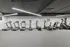 Modern fitness center with sleek treadmills and exercise machines, stylish wall art, and bright lighting.