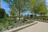 Tranquil outdoor patio with lush gardens and shaded seating, perfect for relaxation and social gatherings.
