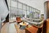 Inviting and modern lobby with floor-to-ceiling windows, cozy seating, and a sleek fireplace, perfect for relaxing or socializing.