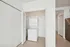 Bright and modern apartment featuring a sleek in-unit washer and dryer set within a spacious closet, ideal for convenient living.