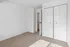 Bright and airy bedroom with plush carpet, ample closet space, and crisp white walls, providing a blank canvas for personal touches.