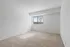 Bright and airy bedroom with plush carpeting and a large window offering serene views.