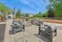 Inviting outdoor patio with modern seating around a cozy fire pit, set against a backdrop of lush greenery and scenic views.