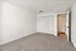 Bright and spacious bedroom with plush carpet, ample closet space, and modern lighting.