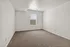 Bright and airy bedroom with plush carpeting and a large window offering natural light.