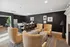 Contemporary lounge area with elegant armchairs, stylish bar seating, and modern decor in a sophisticated setting.