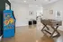 Inviting recreational space featuring a vibrant arcade game and a stylish foosball table, perfect for entertainment and relaxation.