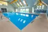 Inviting indoor pool area with skylights and cozy seating, perfect for relaxation and leisure.