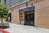 Modern brick facade of Arrive Hollywood leasing office with vibrant signage and inviting entrance.