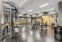 Modern fitness center with state-of-the-art gym equipment, sleek design, and well-lit interior, perfect for energetic workouts.