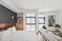 Modern and bright bedroom with sleek furnishings, featuring large windows, elegant wall art, and cozy decor.