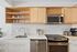 Modern kitchen with sleek stainless steel appliances, elegant cabinetry, and a stylish backsplash.