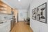 Contemporary kitchen with sleek appliances, warm wooden cabinetry, and a chic dining nook, perfect for modern living.