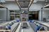 Modern chic lounge with sleek gray sofas, vibrant blue accents, cozy fireplace, and industrial lighting creating an inviting outdoor space.