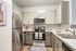 Sleek modern kitchen featuring stainless steel appliances, stylish cabinetry, and a chic subway tile backsplash.
