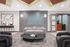 Contemporary living area with plush gray seating, geometric wall art, and a sleek black marble coffee table for luxurious comfort.