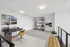 Modern and elegant home office featuring a sleek desk, tasteful art, and a cozy seating area.
