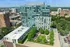 Chic urban high-rise with modern architecture, lush rooftop garden, and scenic city views.