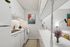 Charming kitchen with modern white cabinetry, cozy sitting area, and stylish decor.