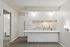 Modern apartment kitchen with sleek white cabinetry, spacious countertops, and inviting natural light.