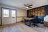 Modern home office with stylish wood accent wall, elegant double doors, and sleek ceiling fan.