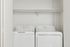 Bright and convenient laundry room with modern washer and dryer set, highlighting functional shelving and space efficiency.