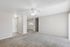 Bright and inviting living space featuring a ceiling fan, plush carpet, and minimalist neutral tones.
