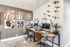 Chic home office with dual workstations, modern art, and calming decorative accents for a productive workspace.