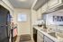 Bright modern kitchen with sleek appliances, stylish cabinetry, and ample counter space, perfect for culinary enthusiasts.
