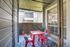 Charming apartment balcony with vibrant red seating and a cozy atmosphere.